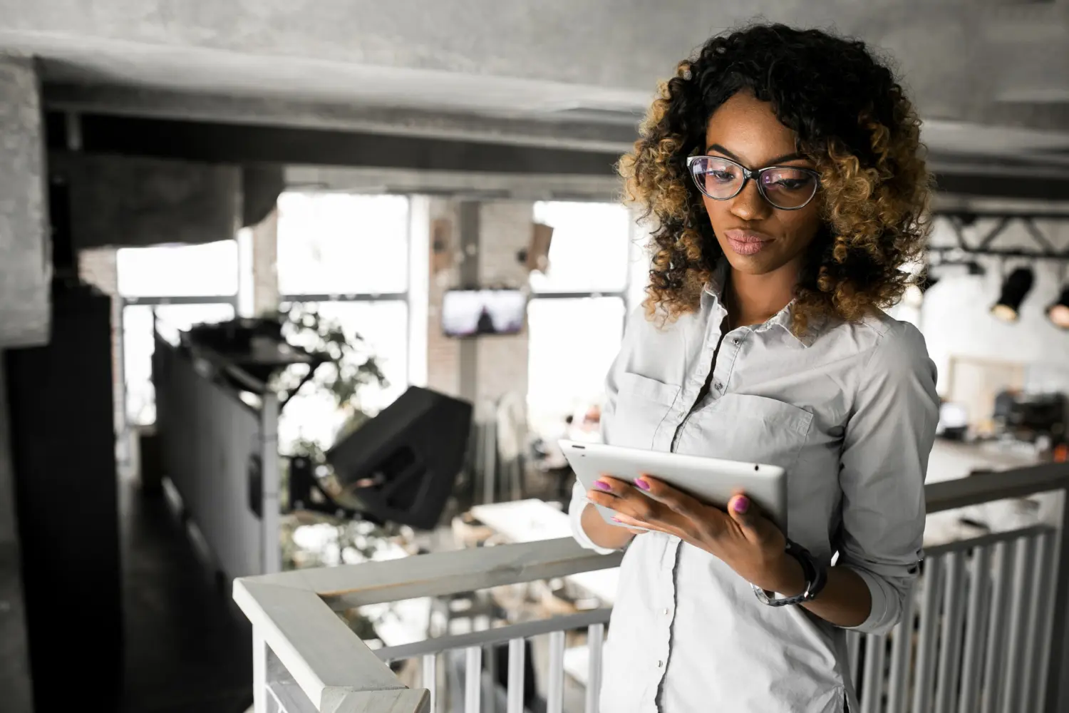 Small business owner using AI and cloud technology solutions in modern office